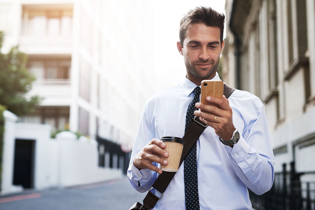 business man in city using his mobile phone