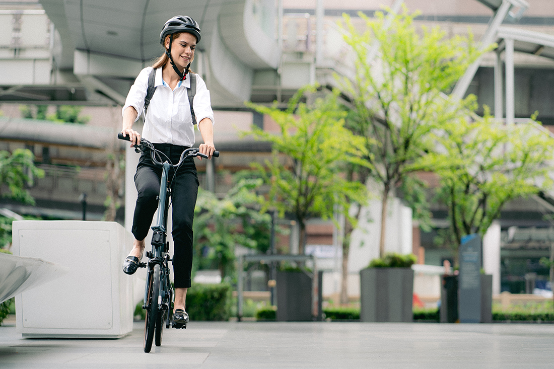 An eco-friendly employee rides a bike to her workplace