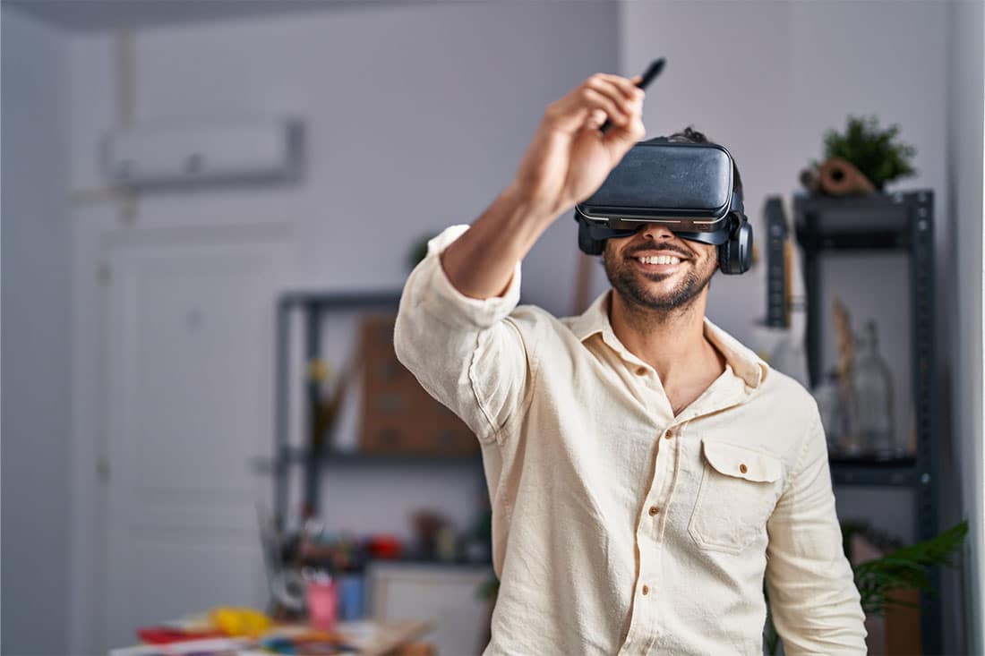 man artist using virtual reality glasses drawing at art studio