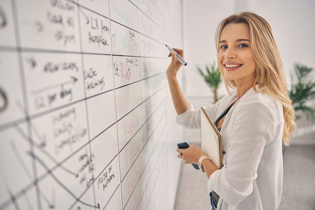 smiling women showing how to organize office for the best production work
