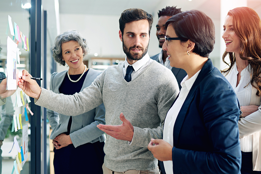 A team leader engages with a group of employees in a brainstorming session