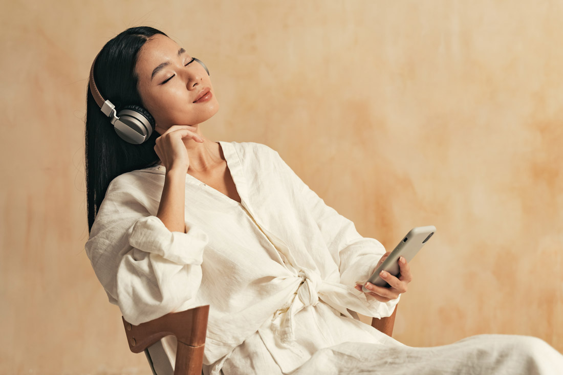 Young women listening to a personal growth podcast